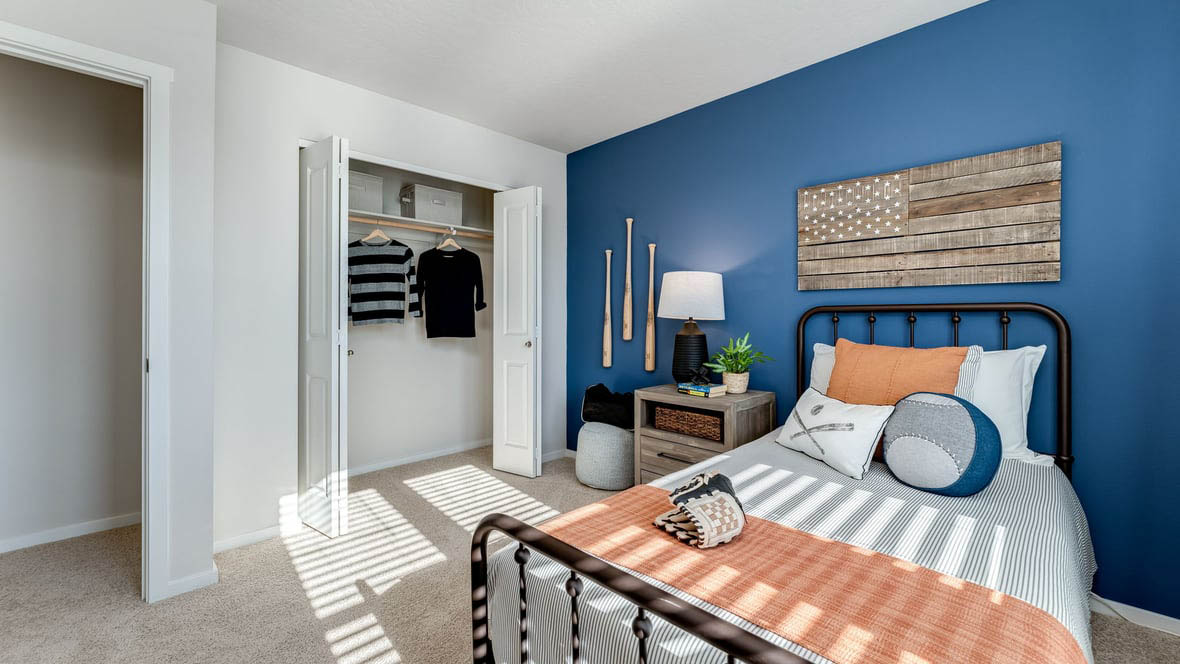 Bedroom with wall-to-wall carpet and a closet
