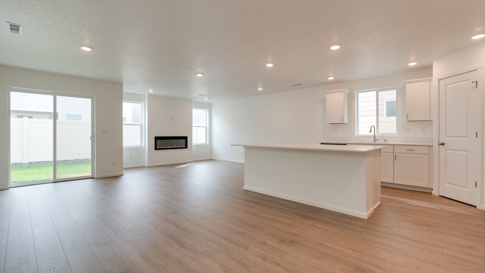 Kitchen with shaker cabinets, quartz counters, stainless steel appliances, pantry, and an island with a breakfast bar