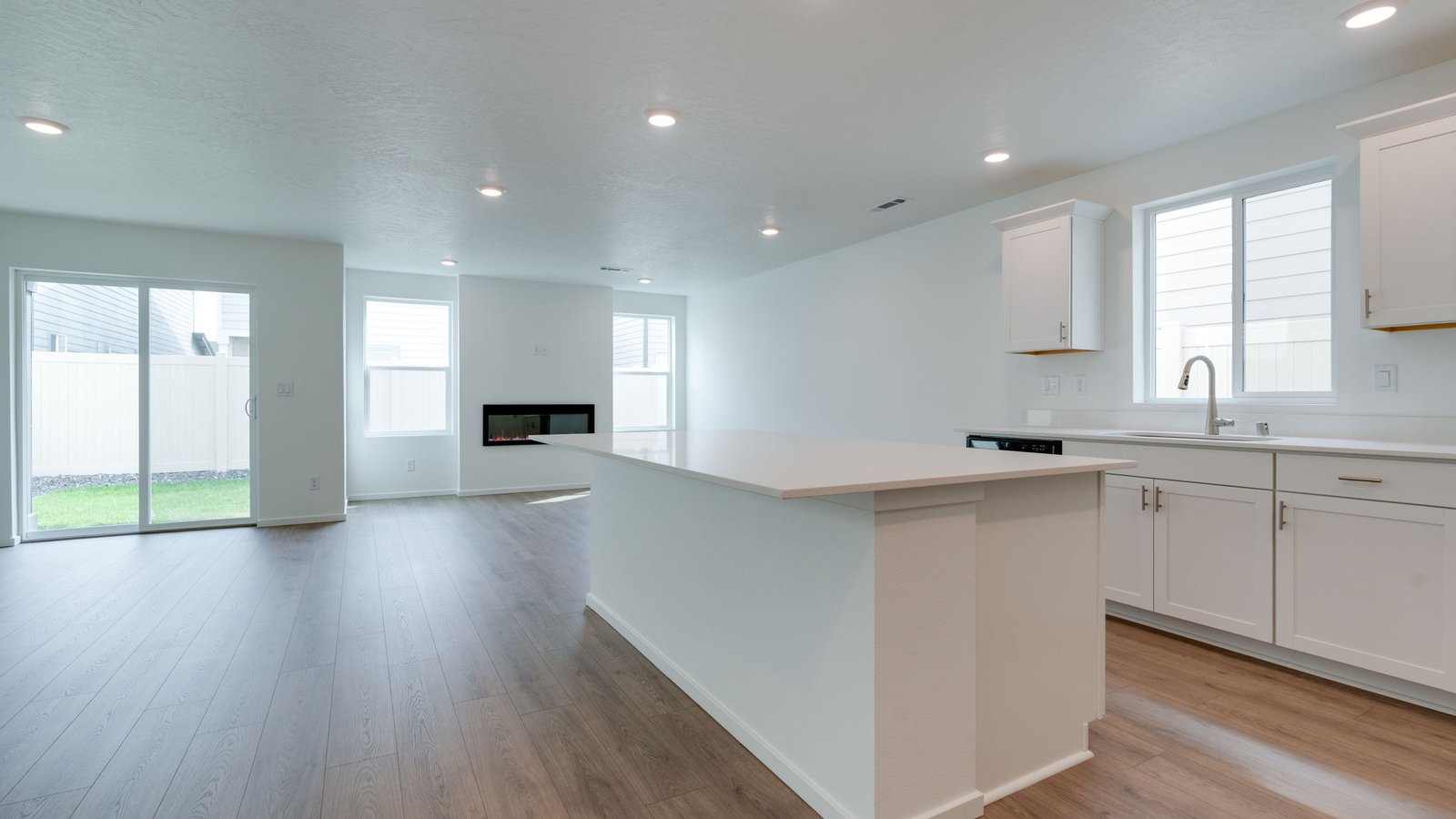 Kitchen with shaker cabinets, quartz counters, stainless steel appliances, pantry, and an island with a breakfast bar
