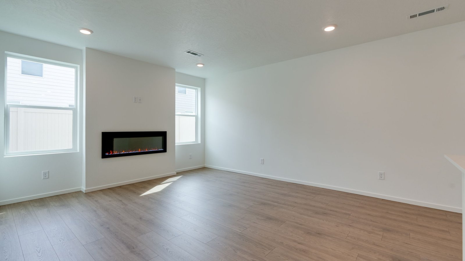Great room with laminate flooring and an electric fireplace