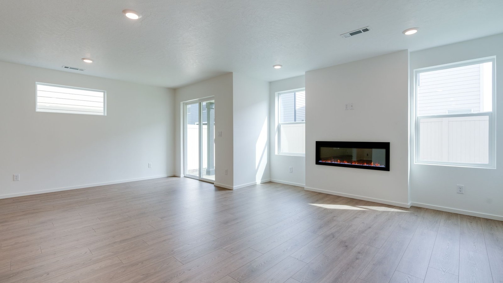 Great room with laminate flooring and an electric fireplace