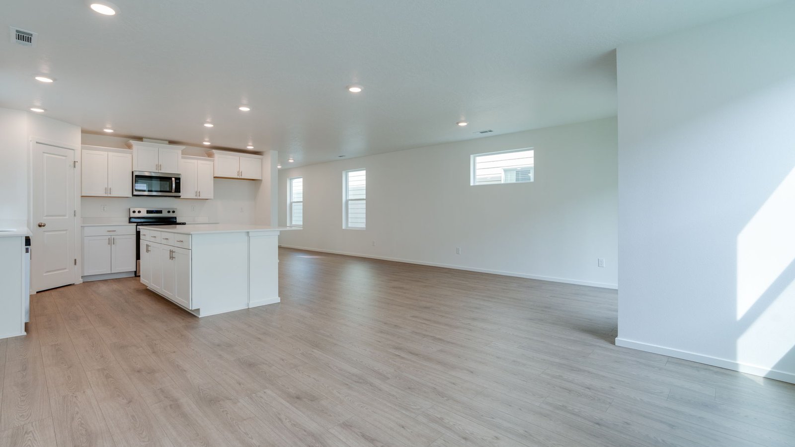 Great room with laminate flooring and an electric fireplace