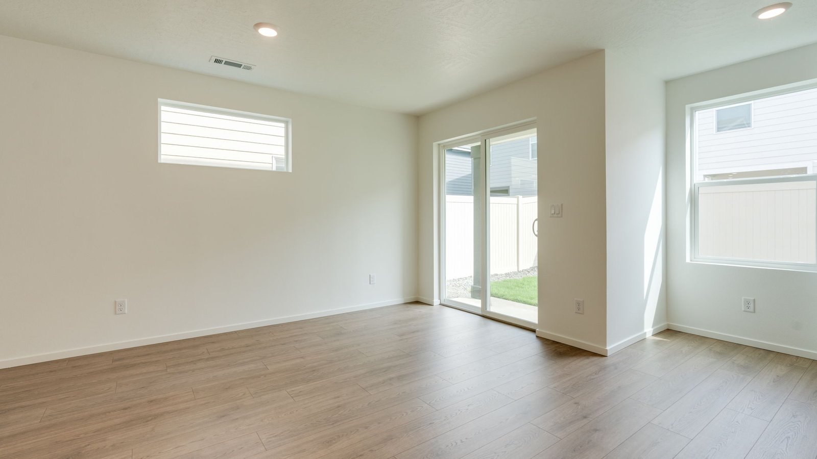 Dining area with a sliding glass door to a fenced backyard
