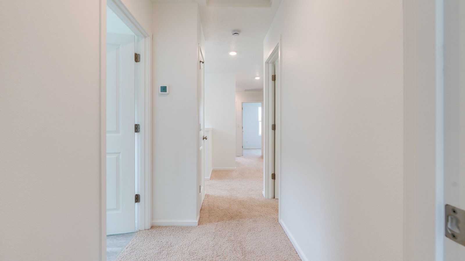 Hallway with wall-to-wall carpet