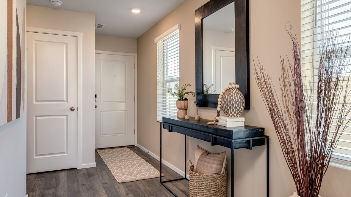 Entryway with a coat closet and laminate flooring