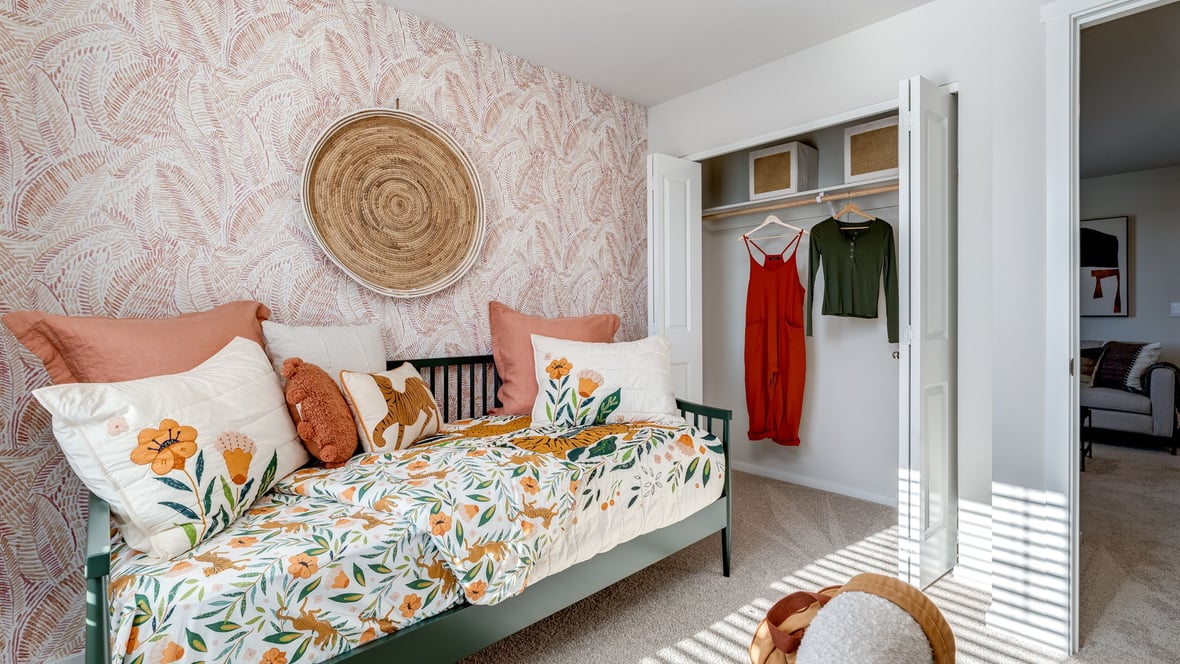 Bedroom with wall-to-wall carpet and a closet