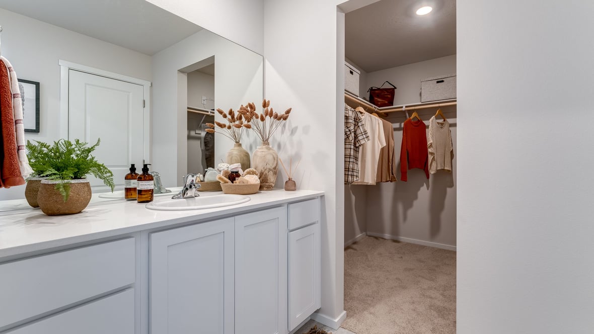 Primary bathroom with quartz counters and a walk-in shower