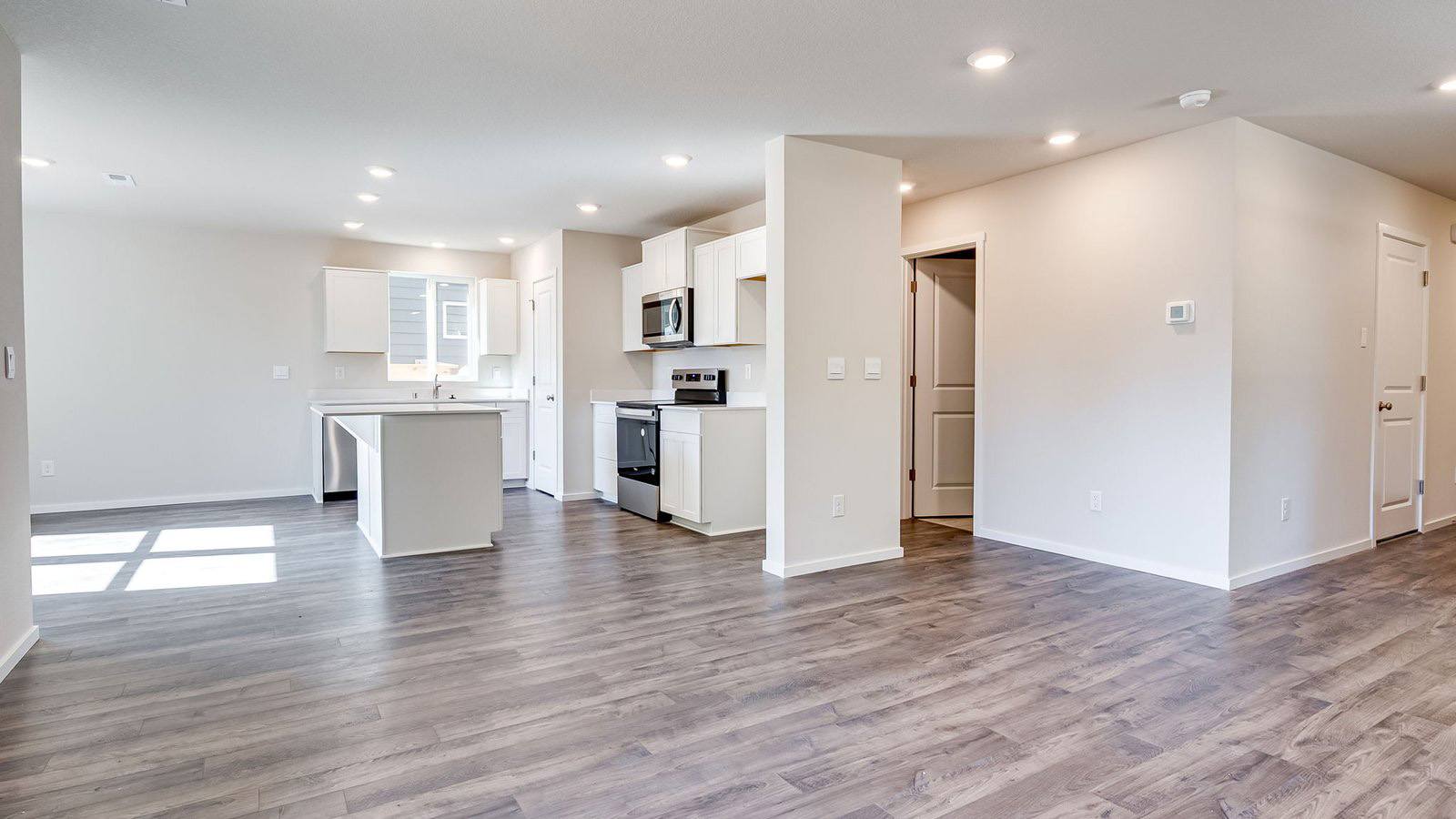 Great room with laminate flooring and an electric fireplace