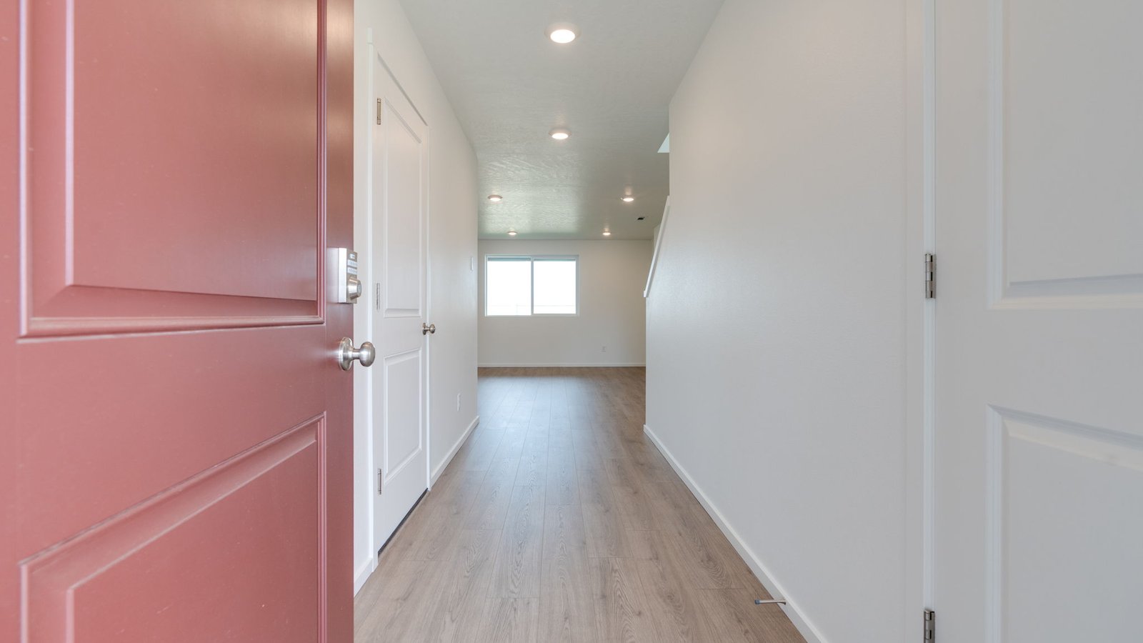 Entryway with a coat closet and laminate flooring