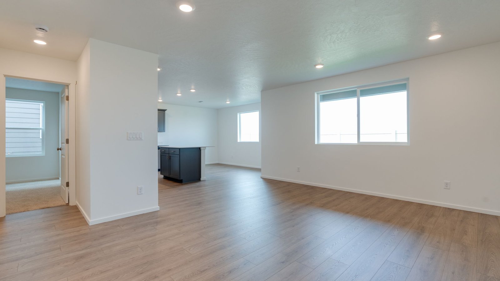 Great room with laminate flooring and an electric fireplace