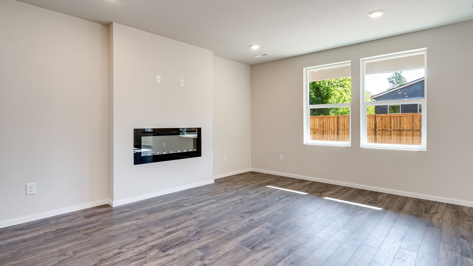 Great room with laminate flooring and an electric fireplace
