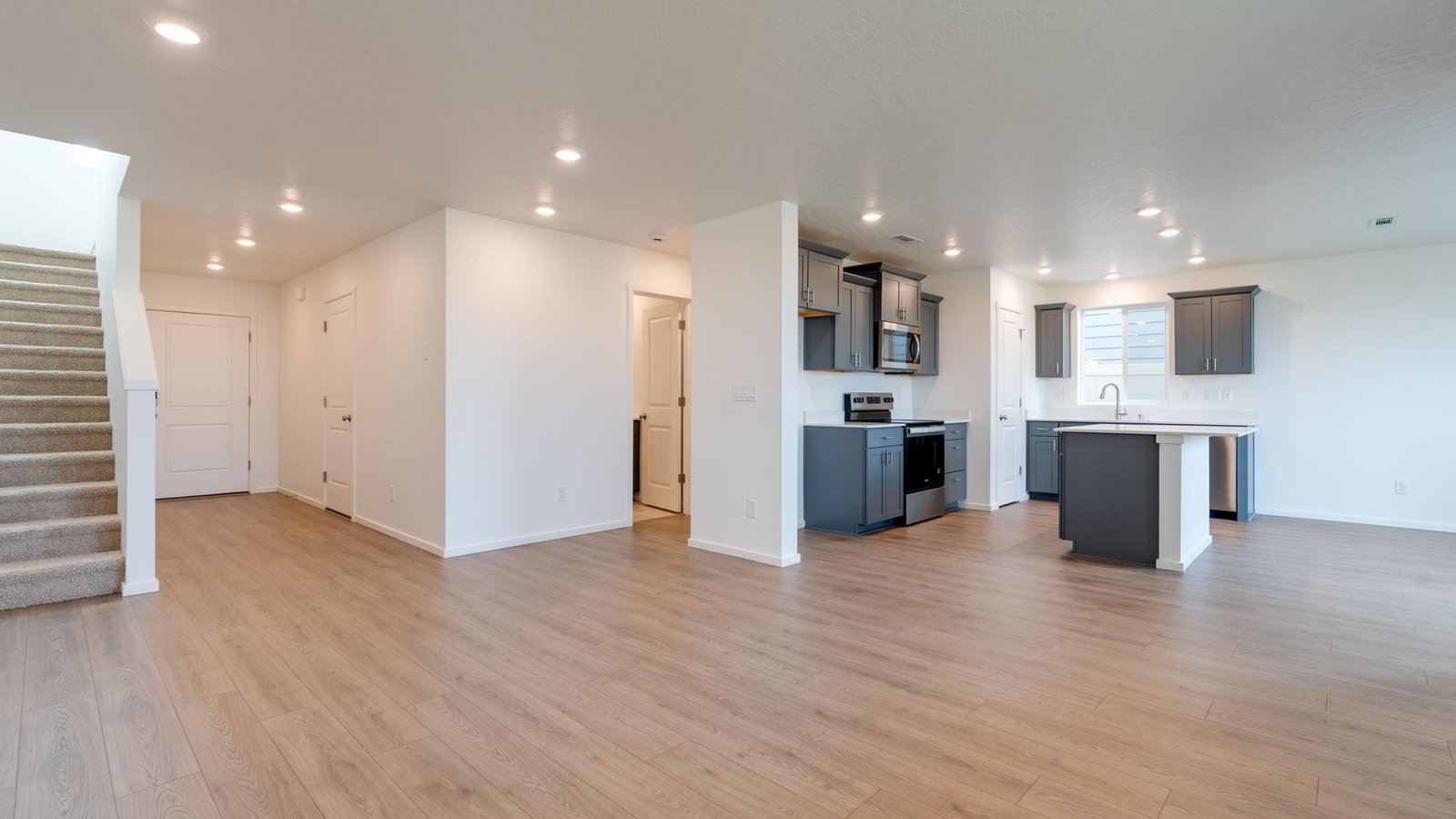 Great room with laminate flooring and an electric fireplace