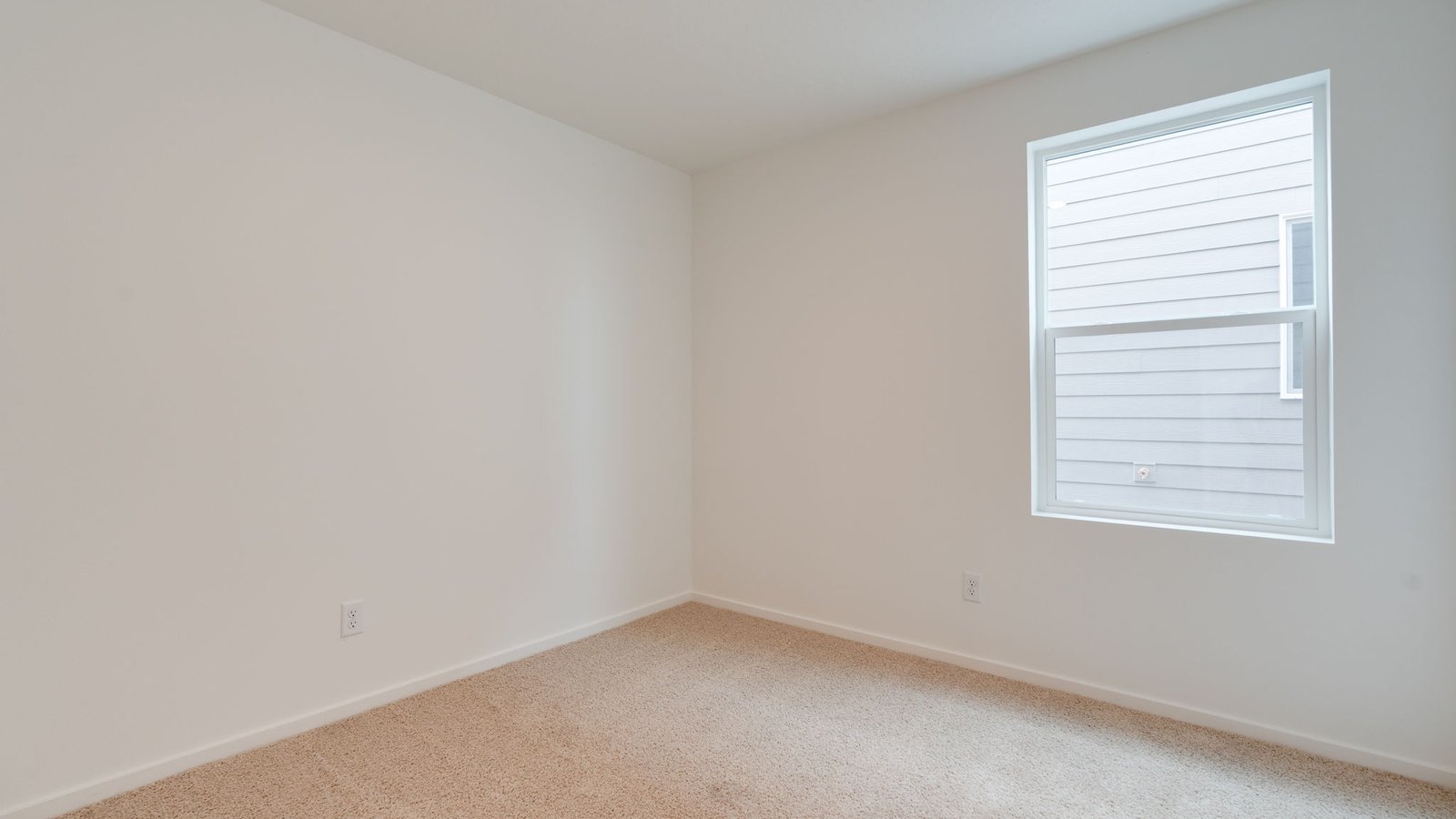 Bedroom with wall-to-wall carpet and a closet