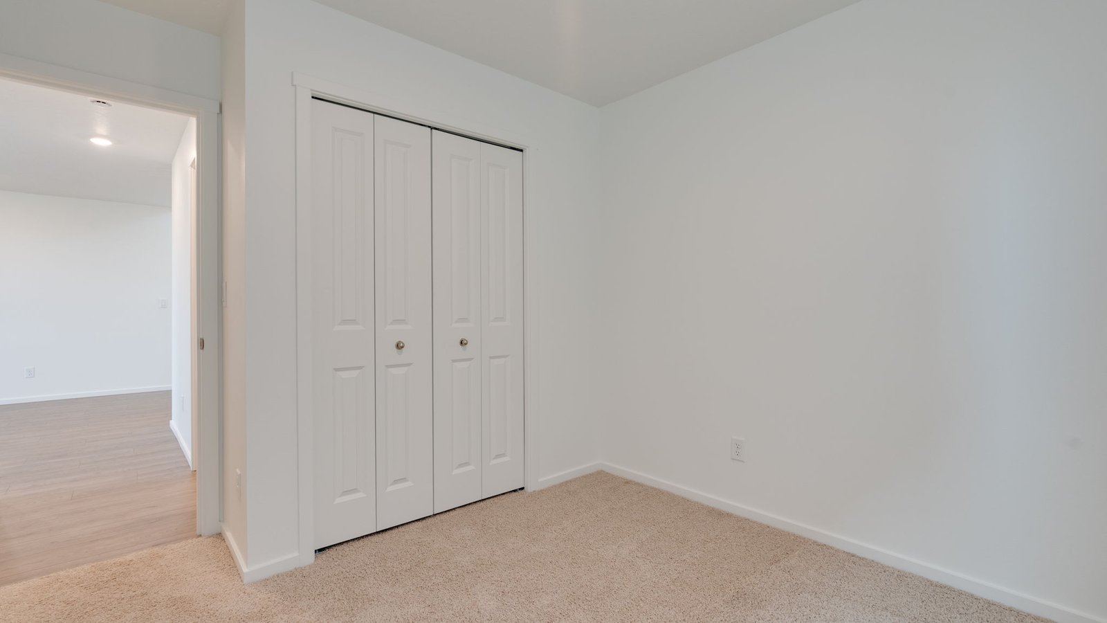 Bedroom with wall-to-wall carpet and a closet