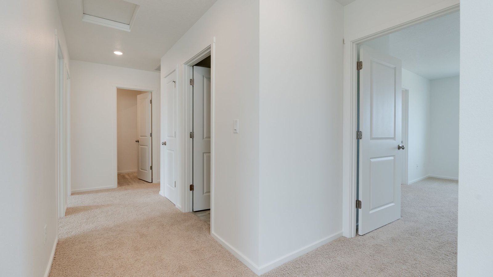 Hallway with wall-to-wall carpet