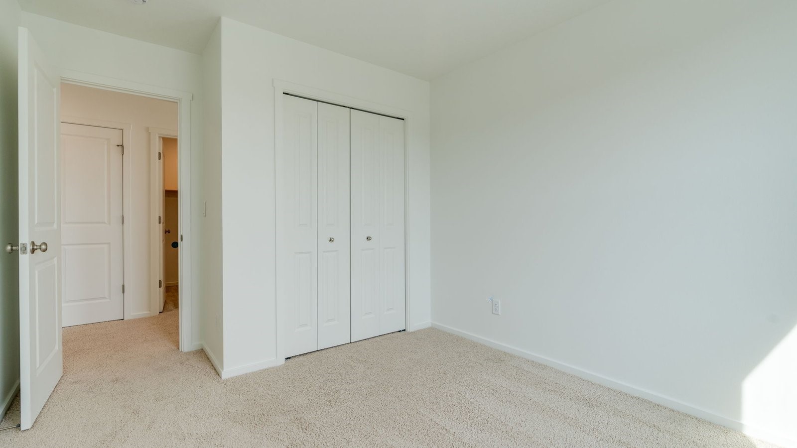 Bedroom with wall-to-wall carpet and a closet