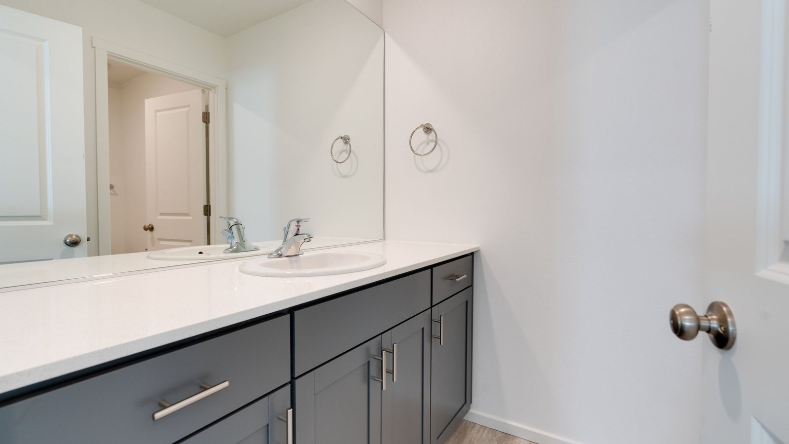 Primary bathroom with quartz counters and a walk-in shower