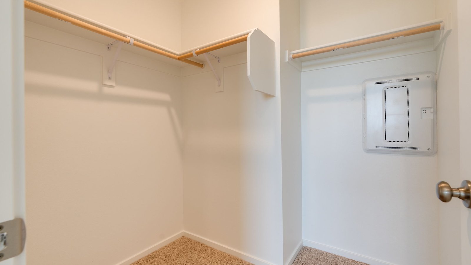 Primary bedroom walk-in closet with built-in shelves