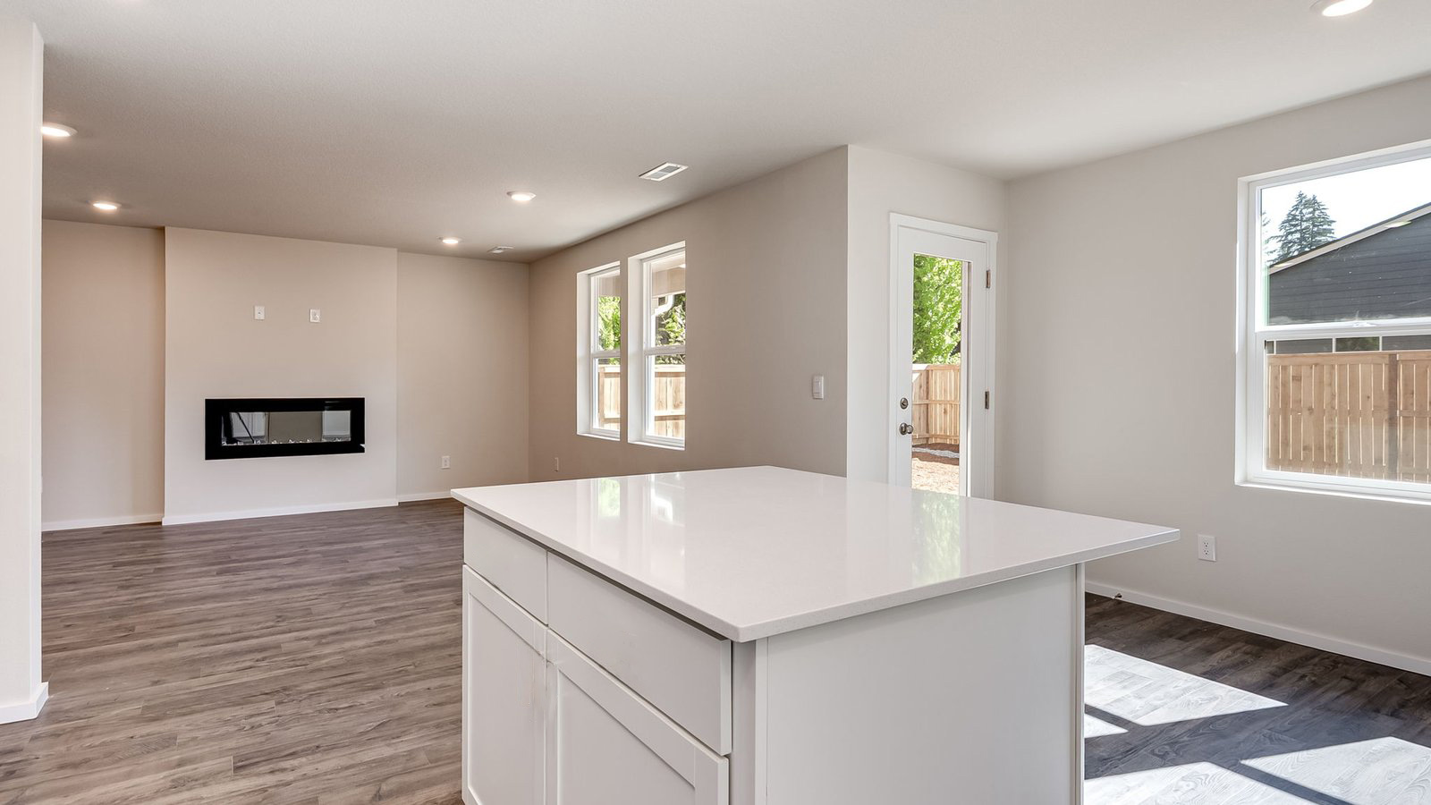 Kitchen with shaker cabinets, quartz counters, stainless steel appliances, pantry, and an island with a breakfast bar