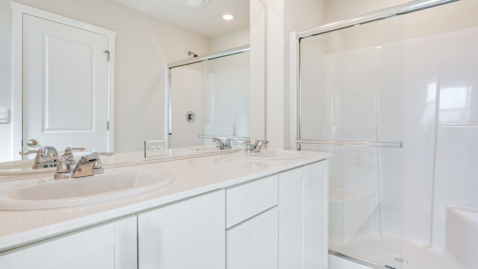 Primary bathroom with quartz counters and a walk-in shower