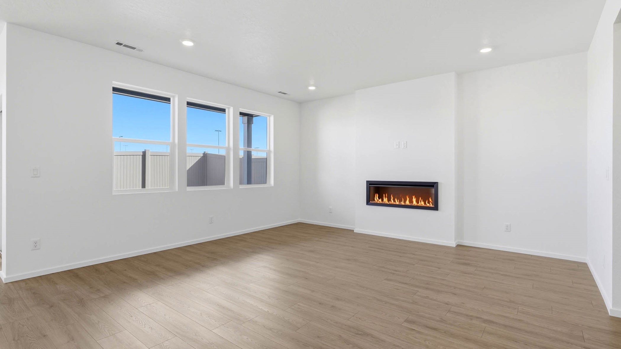 Great room with laminate flooring and an electric fireplace