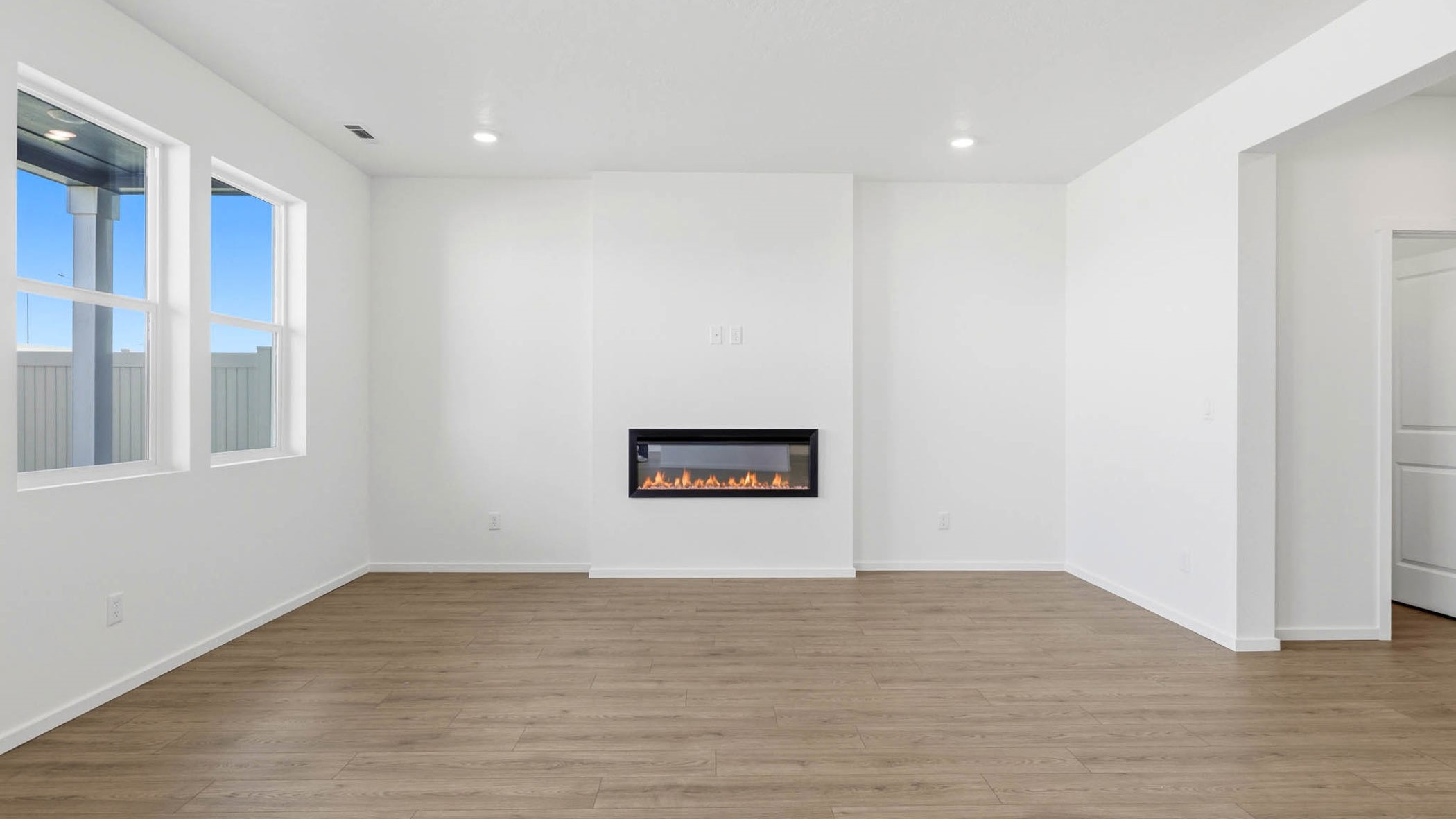 Great room with laminate flooring and an electric fireplace