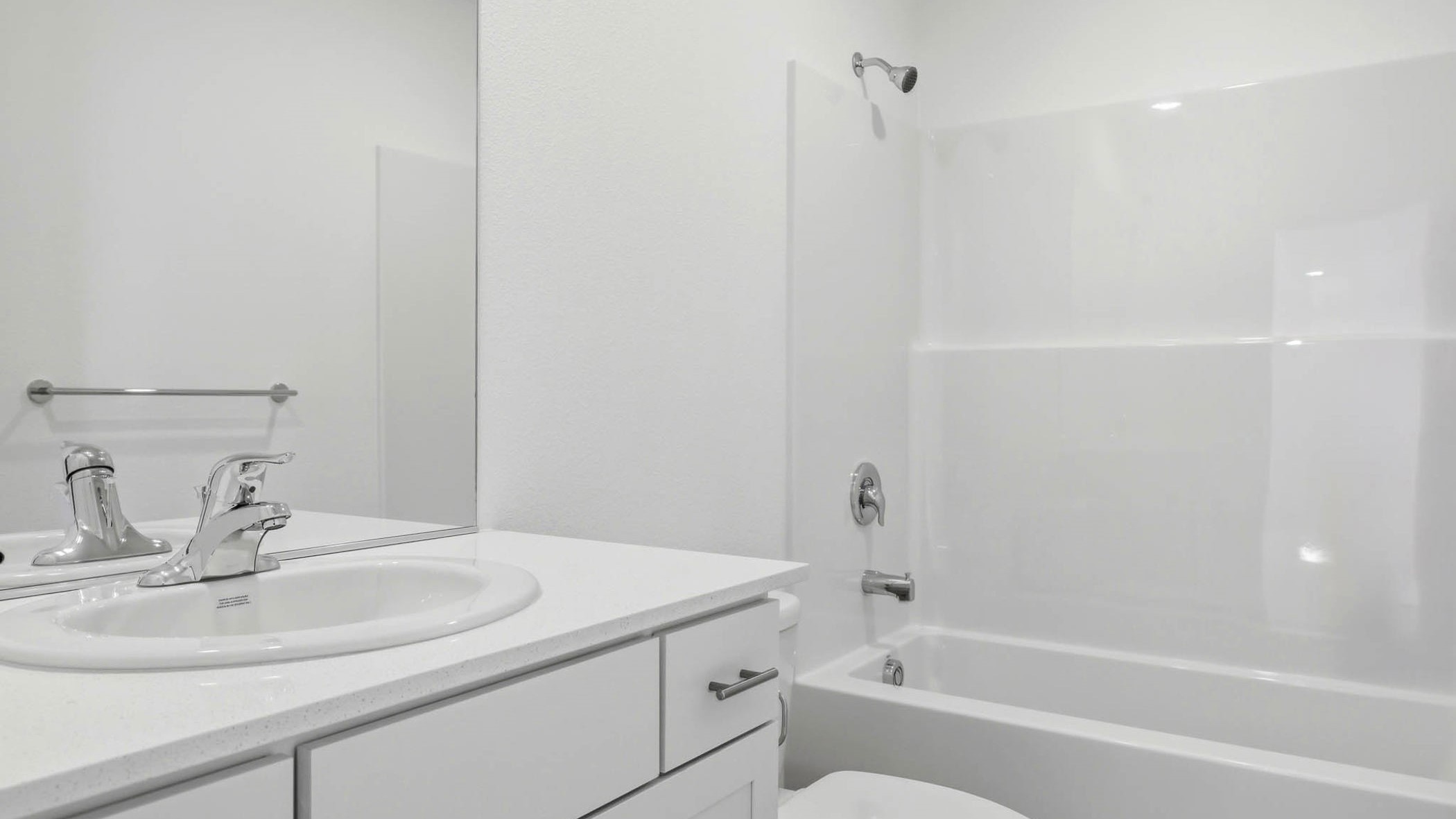 Hall bathroom with combination tub/shower and quartz counters