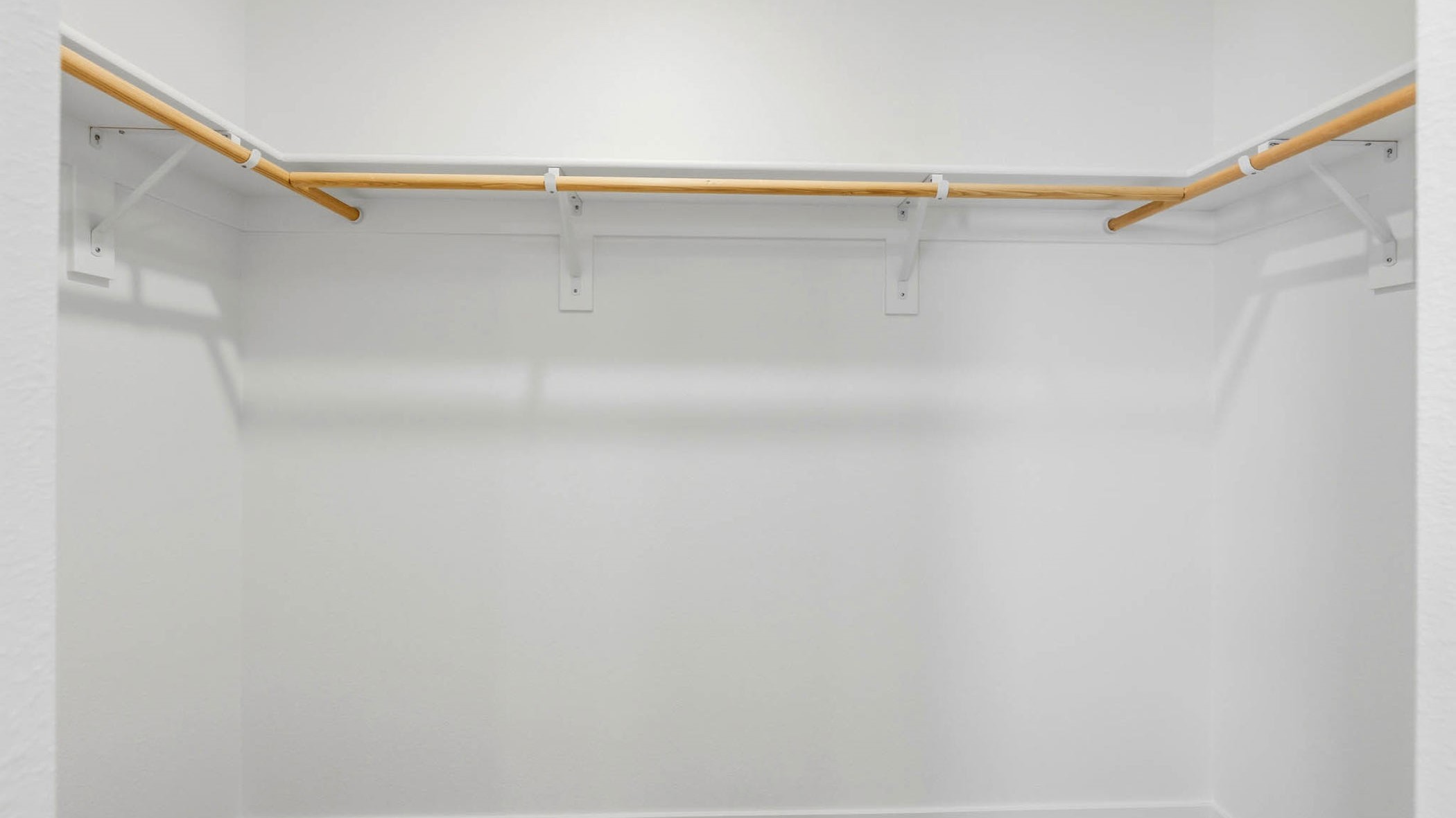 Primary bedroom walk-in closet with built-in shelves