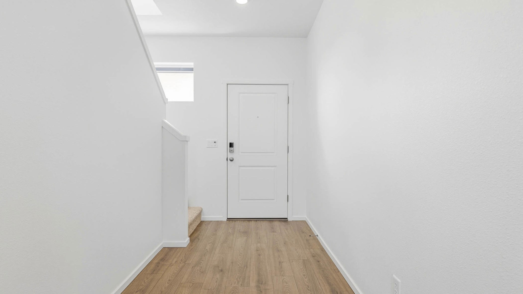 Entryway with a coat closet and laminate flooring