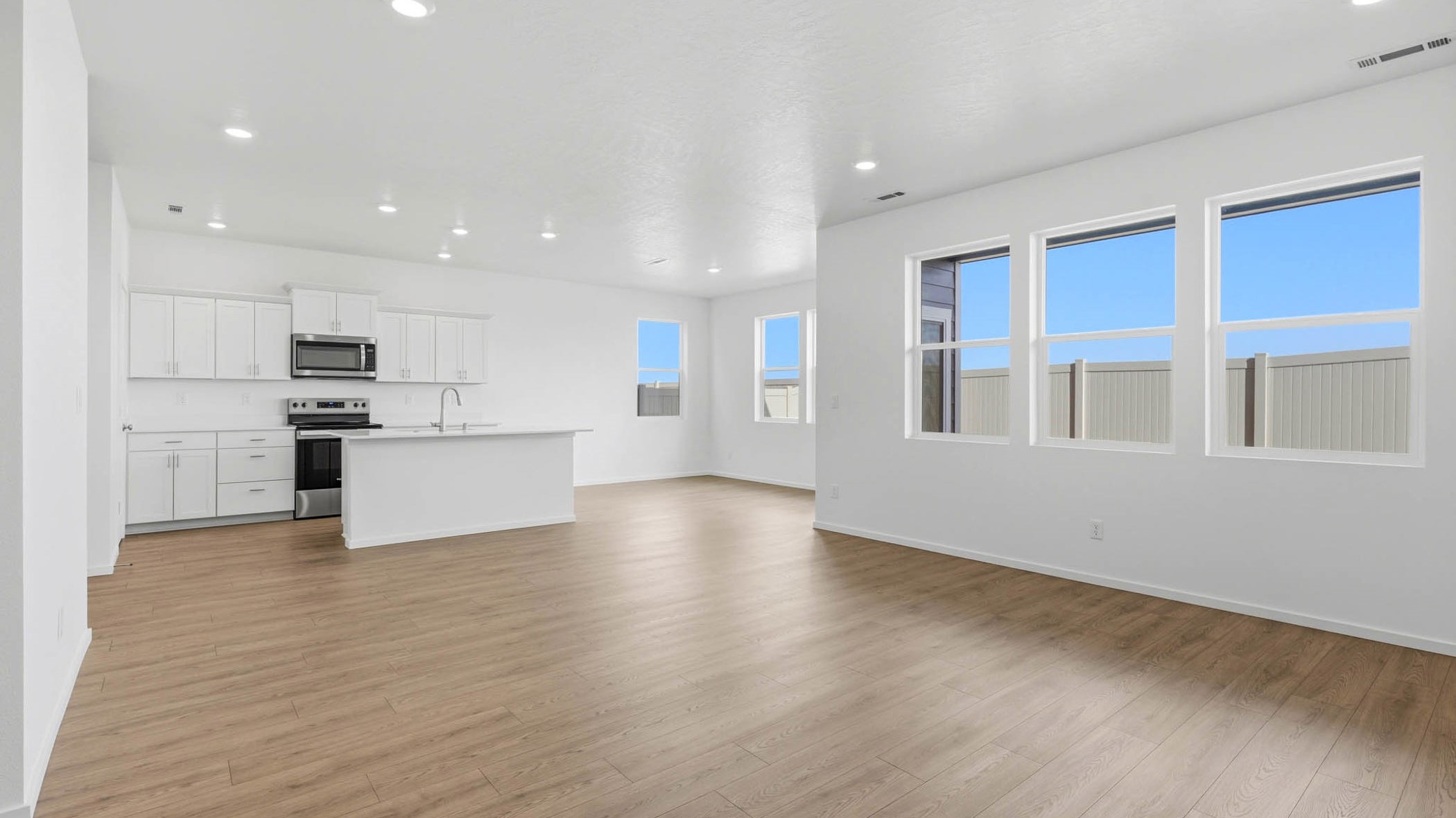 Great room with laminate flooring and an electric fireplace