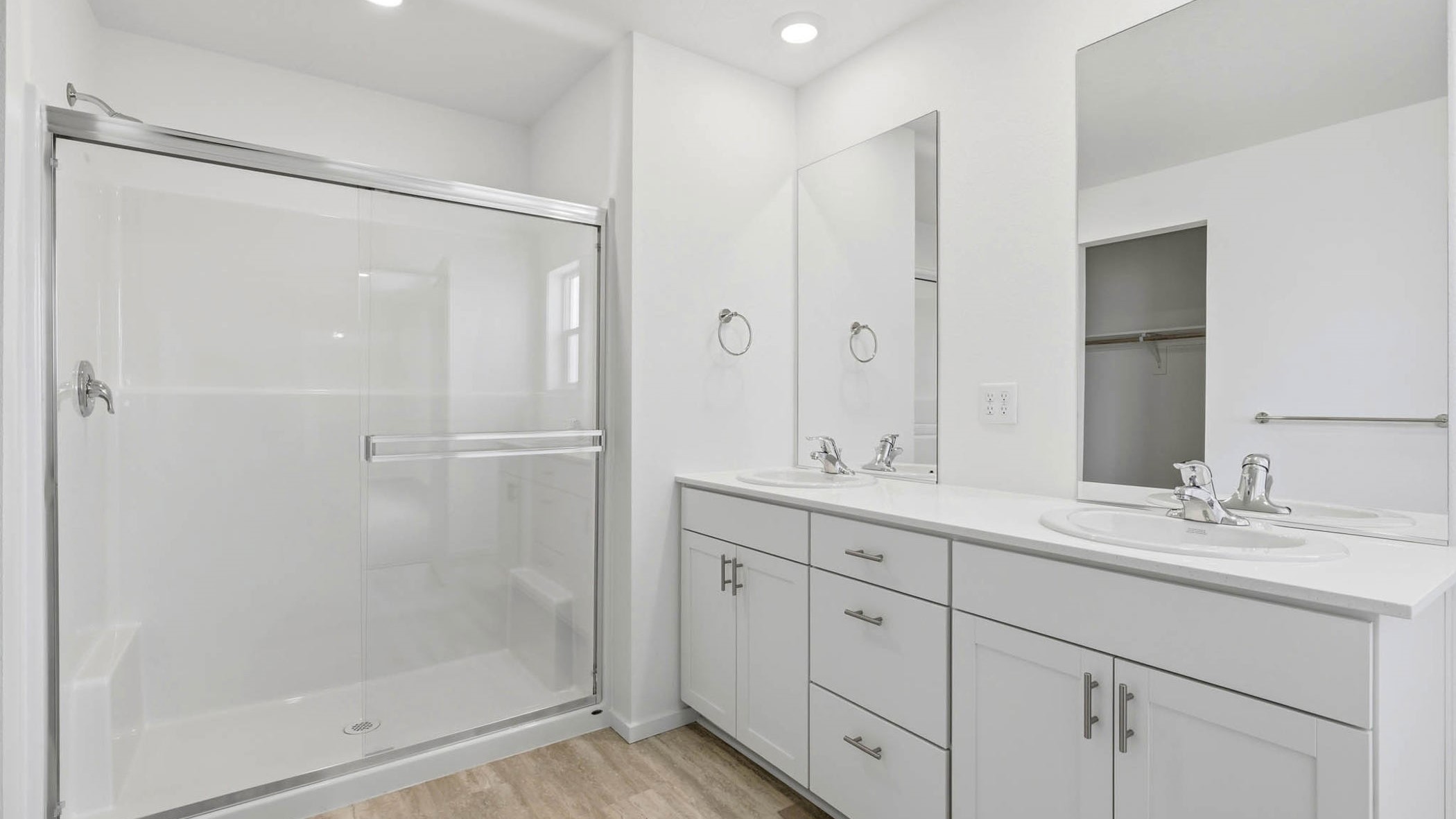 Primary bathroom with quartz counters and a walk-in shower
