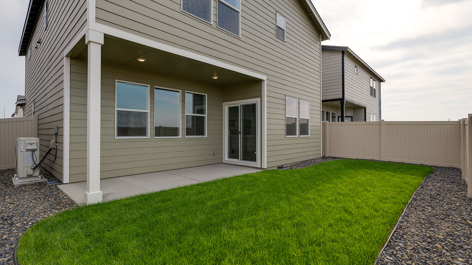 backyard with vinyl plank fence and covered patio