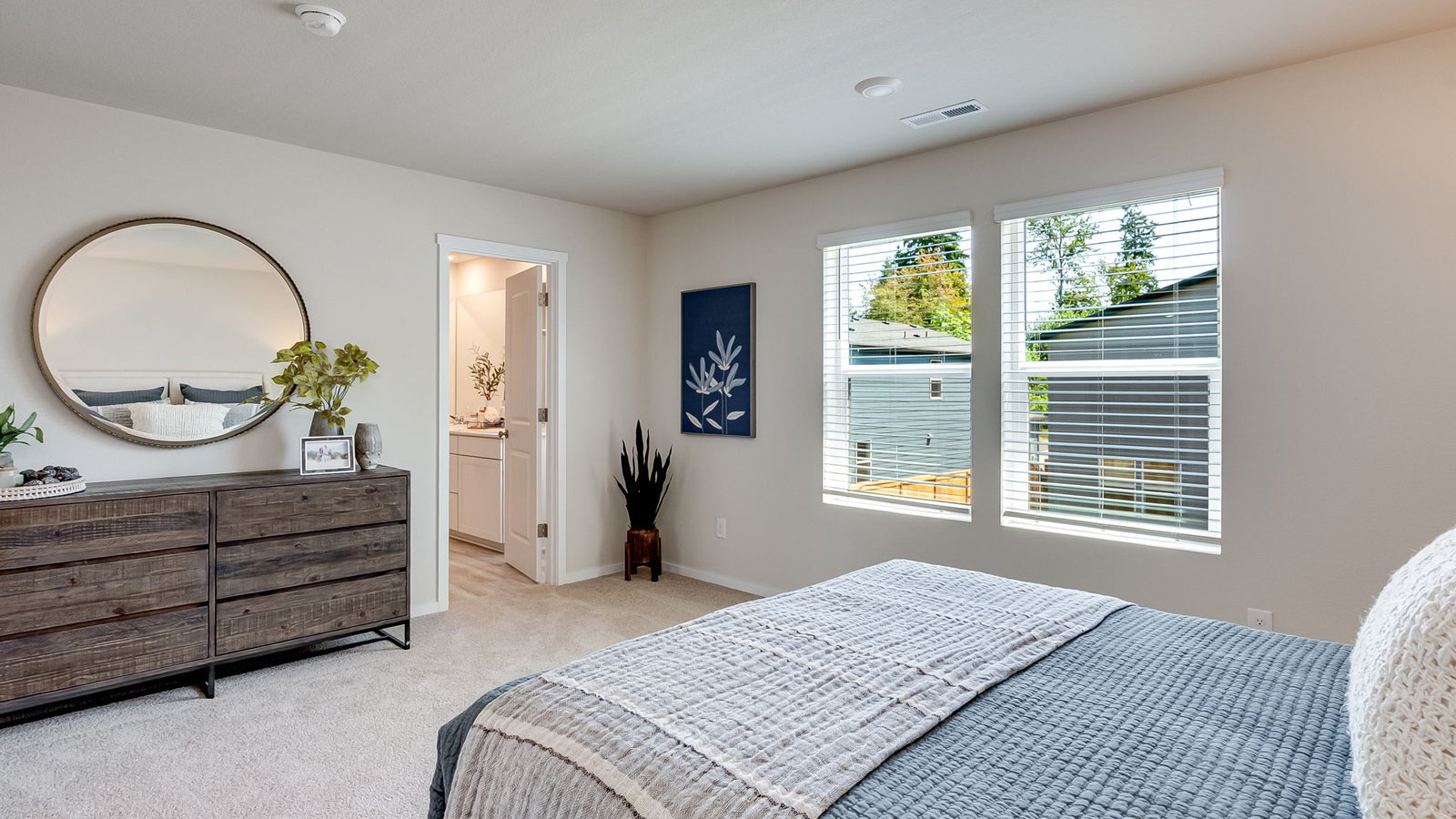 Primary bedroom with wall-to-wall carpet, a walk-in closet and an attached bathroom