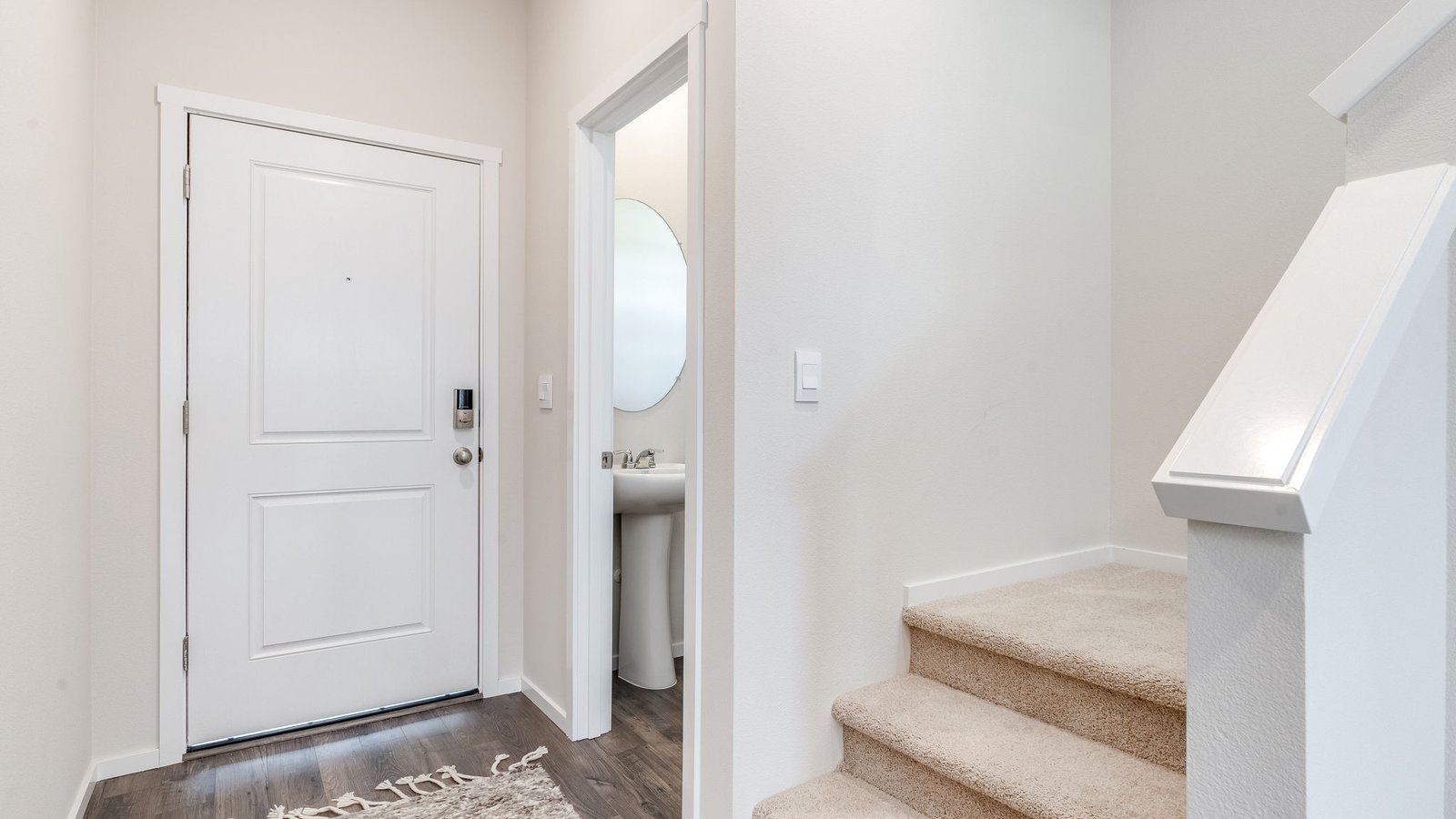 Entryway with a coat closet and laminate flooring