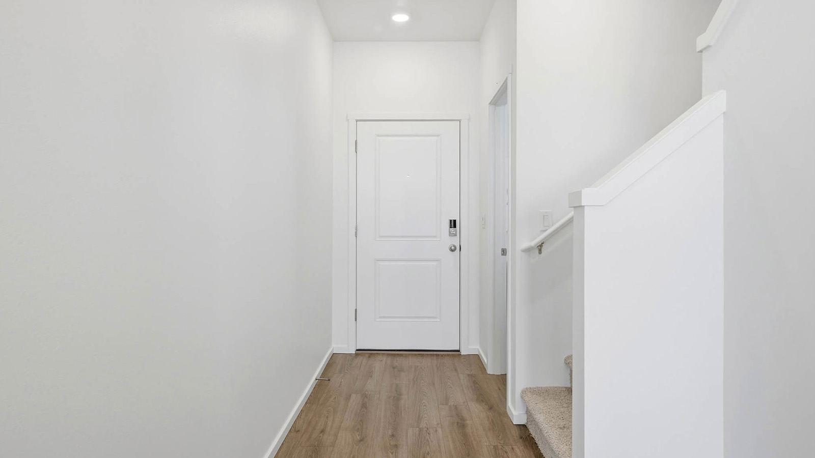 Entryway with a coat closet and laminate flooring