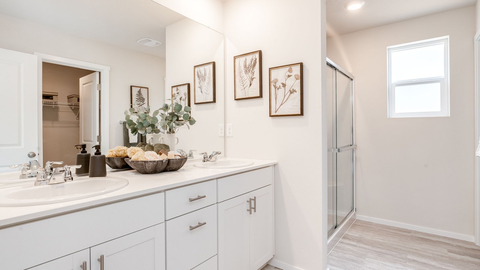 Primary bathroom with quartz counters and a walk-in shower