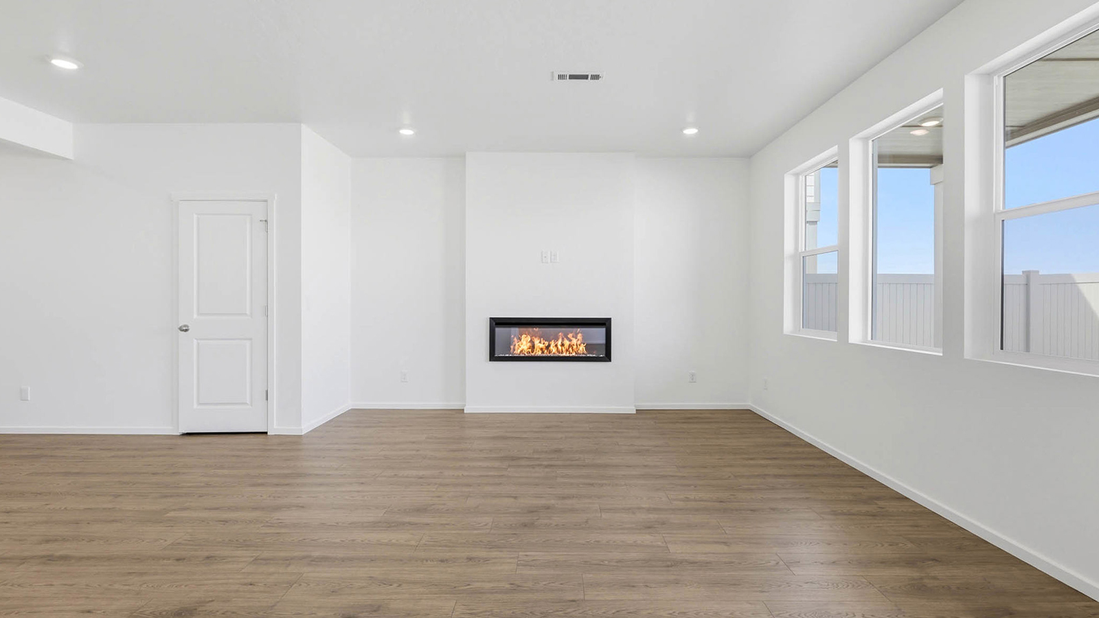 Great room with laminate flooring and an electric fireplace