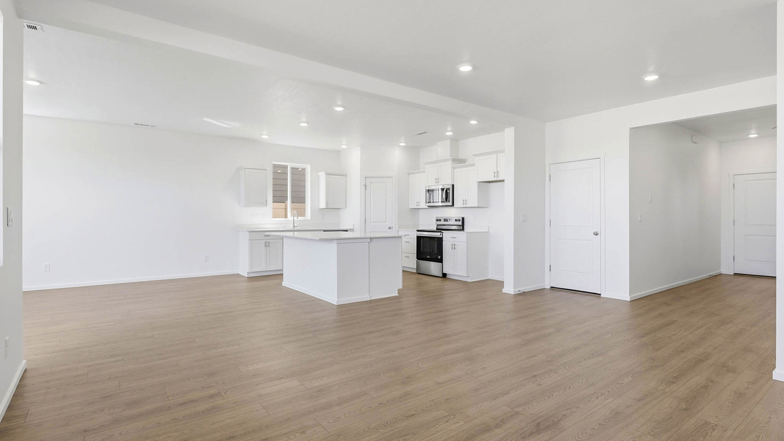 Great room with laminate flooring and an electric fireplace