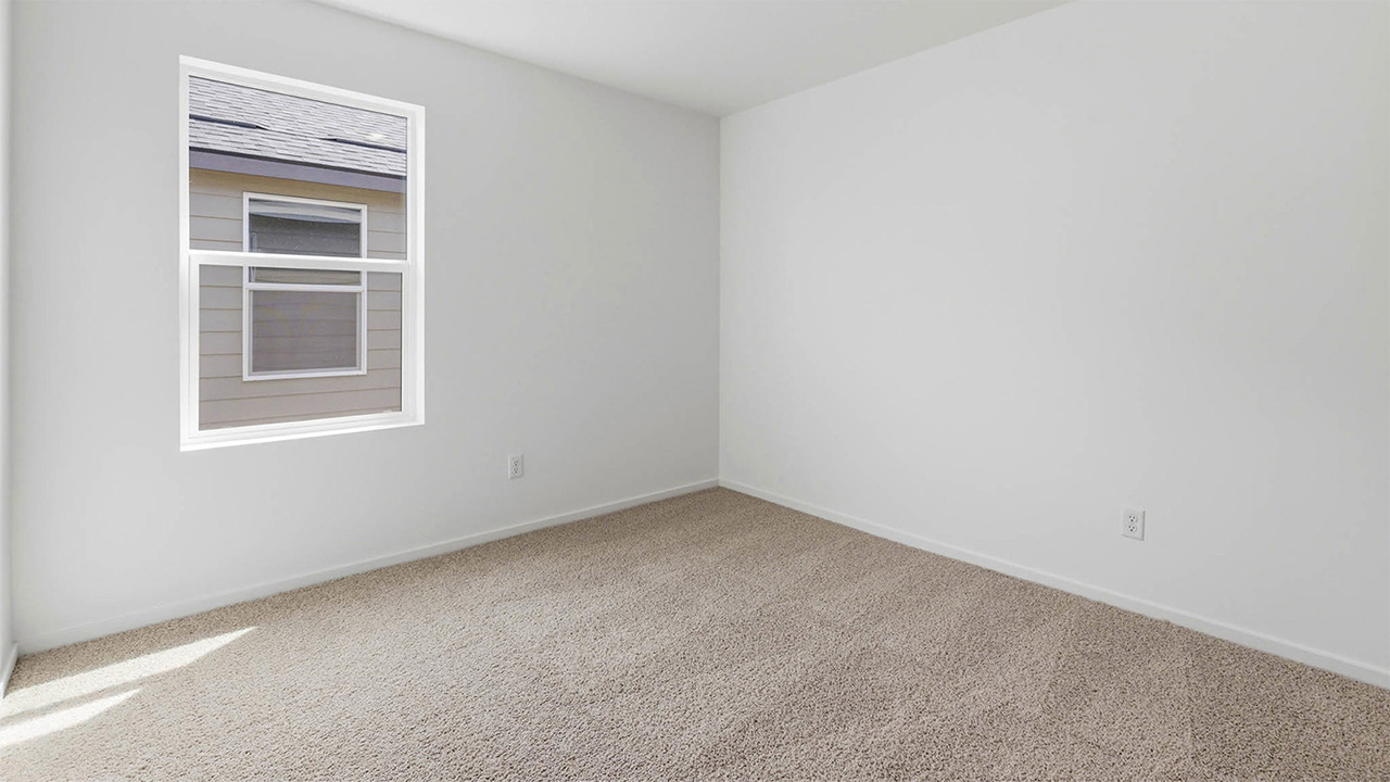 Bedroom with wall-to-wall carpet and a closet