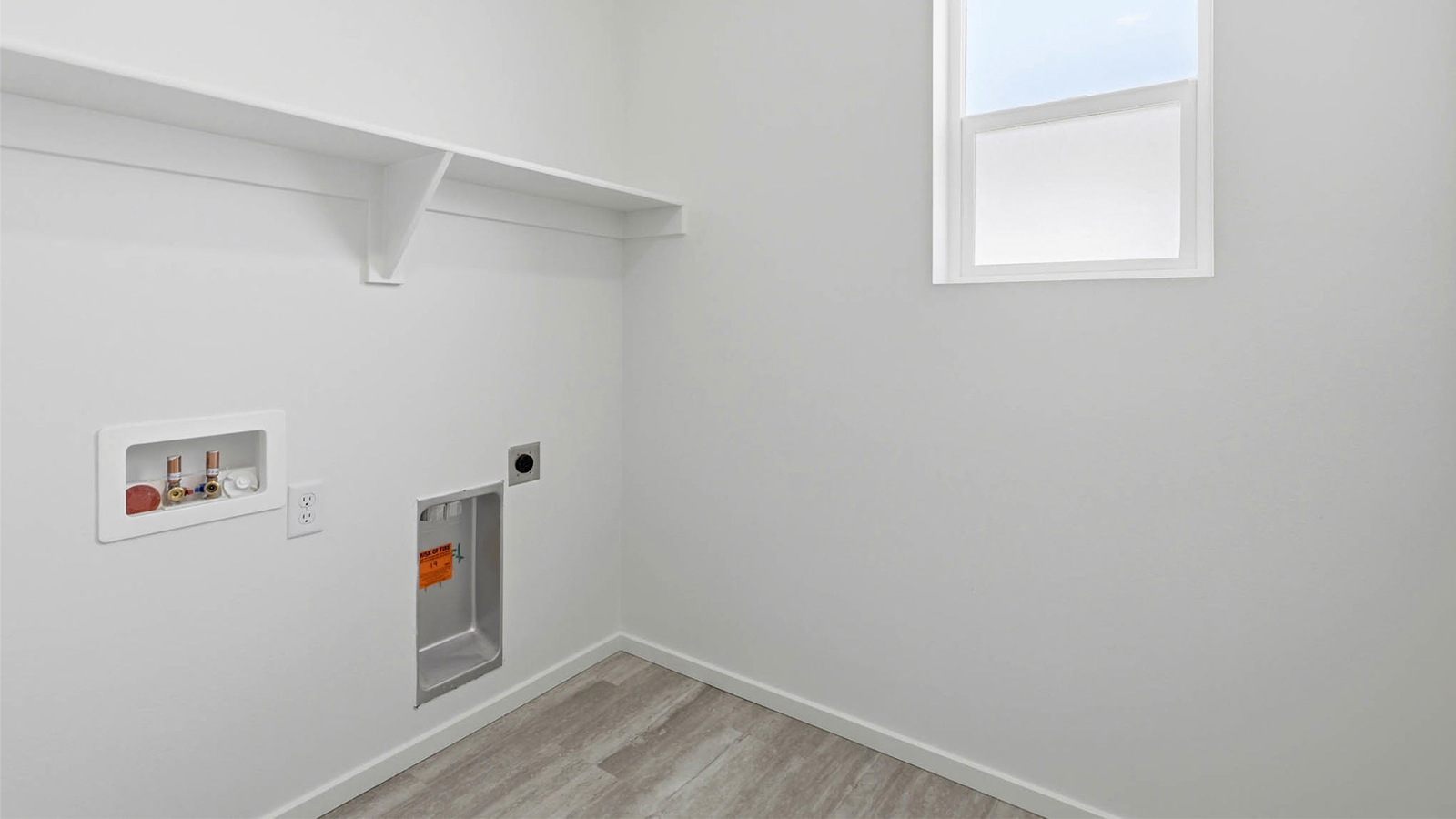 Laundry room with built-in shelves and washer and dryer hookups