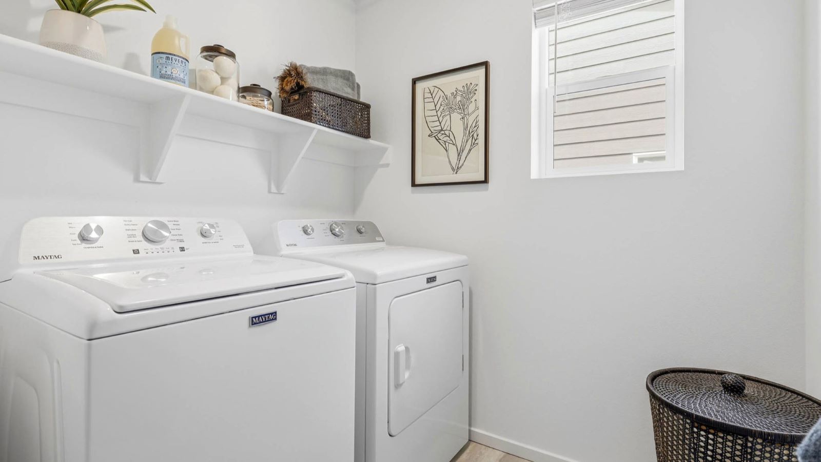 Laundry room with built-in shelves and washer and dryer hookups