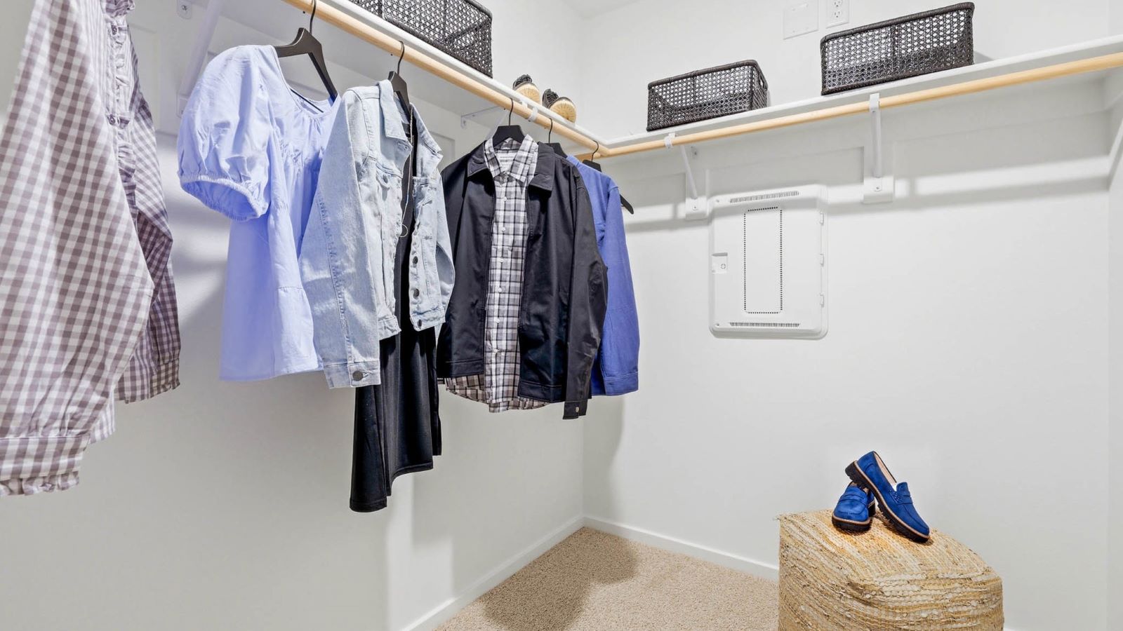 Primary bedroom walk-in closet with built-in shelves