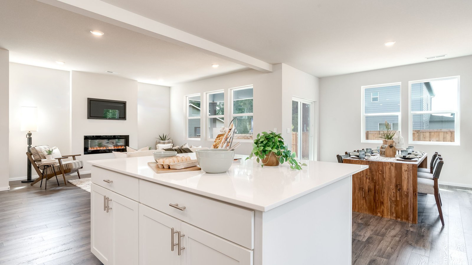 Kitchen with shaker cabinets, quartz counters, stainless steel appliances, pantry, and an island with a breakfast bar