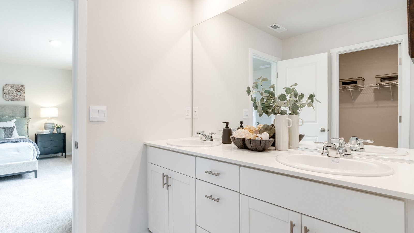 Primary bathroom with quartz counters and a walk-in shower