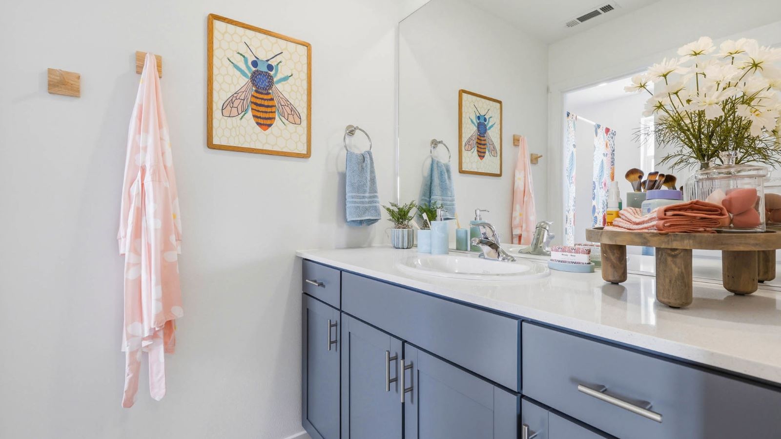 Primary bathroom with quartz counters and a walk-in shower