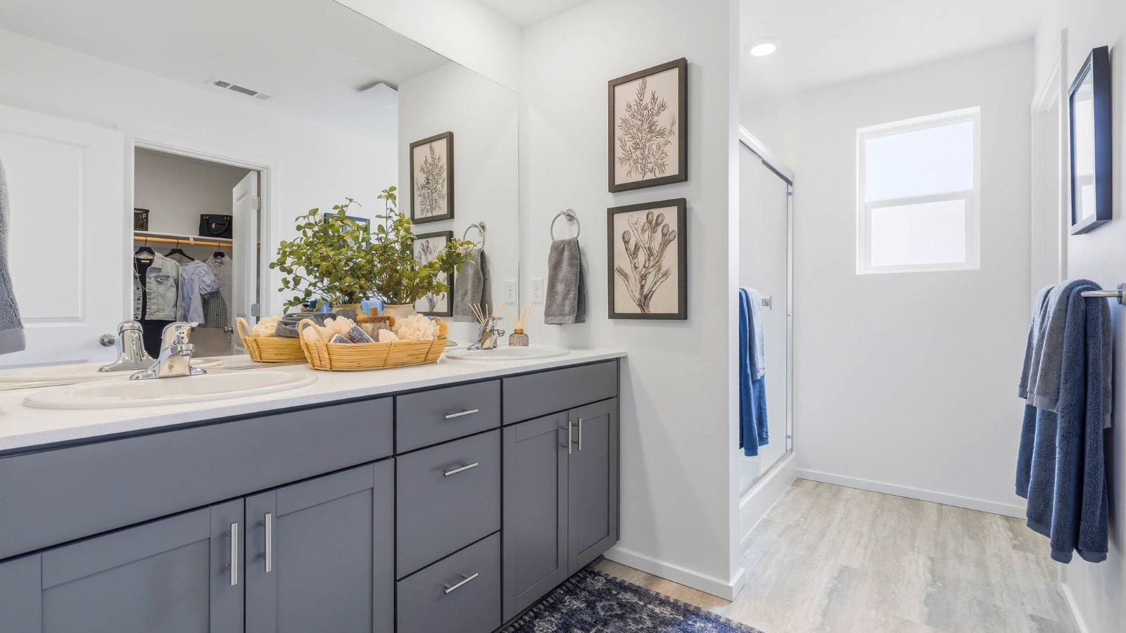 Primary bathroom with quartz counters and a walk-in shower