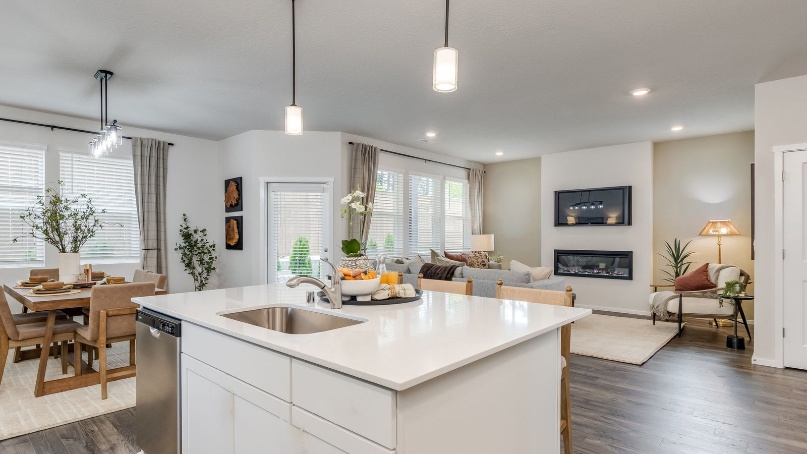 Kitchen with shaker cabinets, quartz counters, stainless steel appliances, pantry, and an island with a breakfast bar