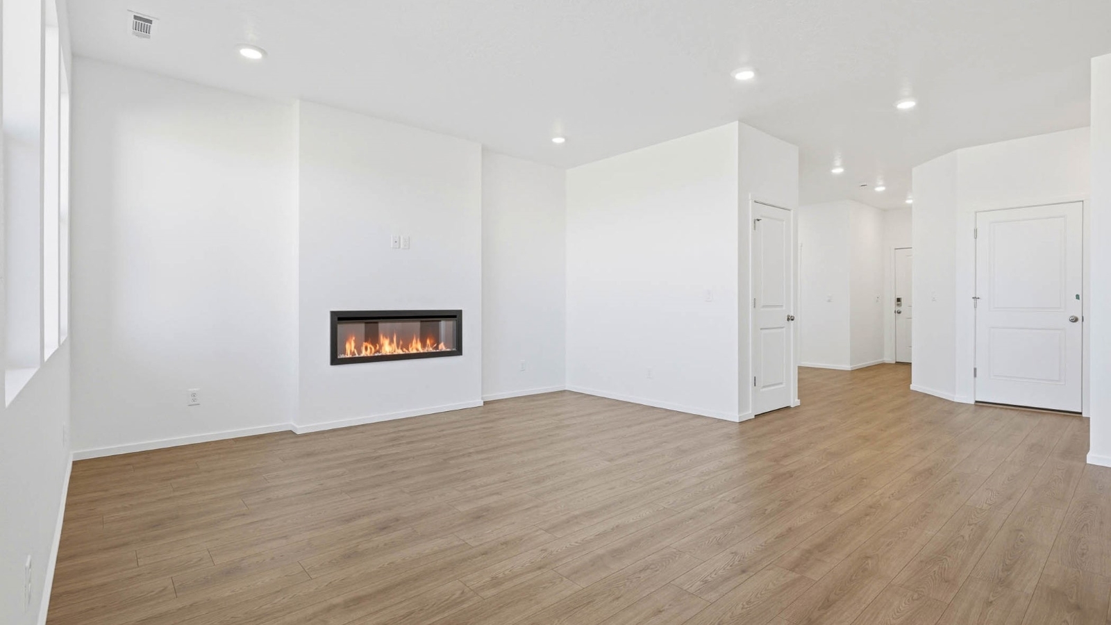 Great room with laminate flooring and an electric fireplace