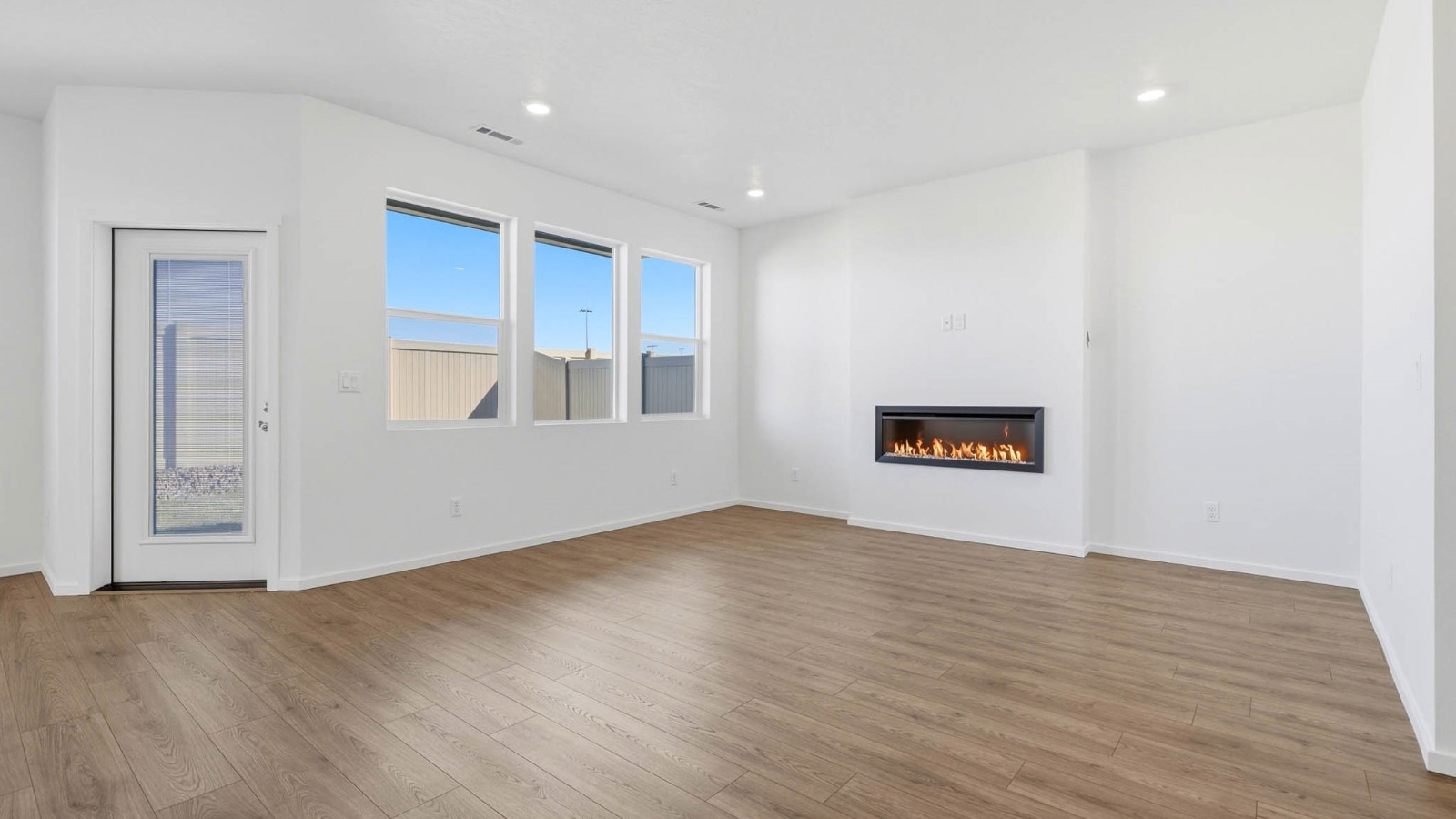 Great room with laminate flooring and an electric fireplace
