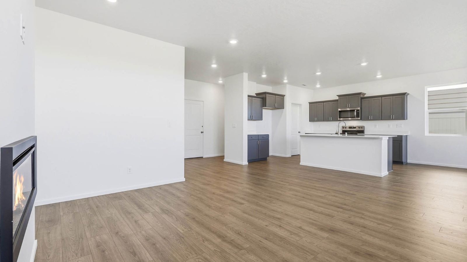 Great room with laminate flooring and an electric fireplace